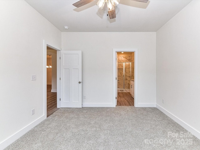 unfurnished bedroom with connected bathroom, baseboards, and carpet floors