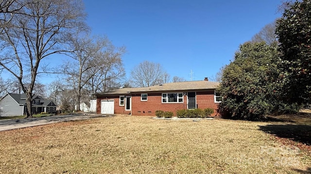 ranch-style home featuring driveway, a chimney, a garage, crawl space, and brick siding