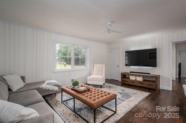 living area featuring visible vents, ornamental molding, a ceiling fan, and dark wood-style flooring