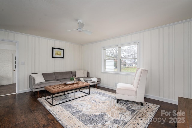 living area with wood finished floors, baseboards, and ceiling fan