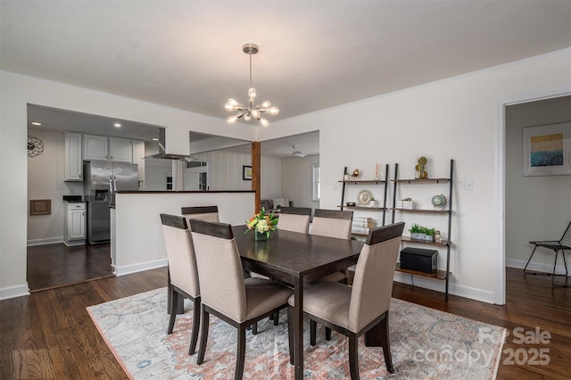 dining room with an inviting chandelier, dark wood-style floors, baseboards, and ornamental molding