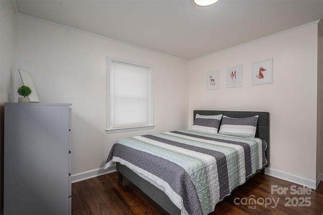 bedroom featuring wood finished floors, baseboards, and ornamental molding