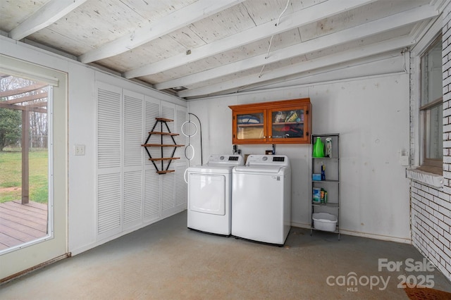 clothes washing area with laundry area, separate washer and dryer, and a healthy amount of sunlight