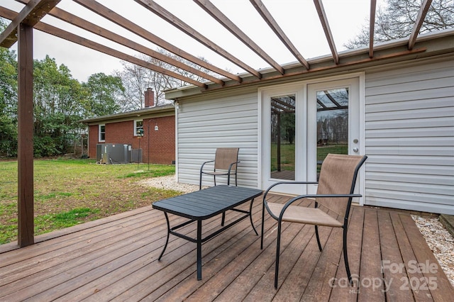 wooden deck featuring cooling unit, a lawn, and a pergola