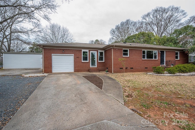 ranch-style house with crawl space, brick siding, a garage, and driveway