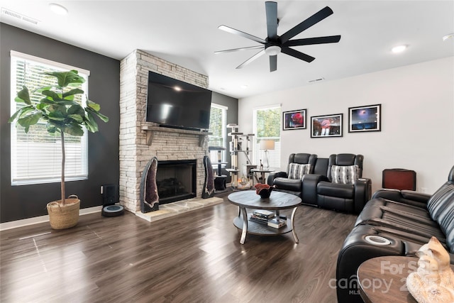 living area with plenty of natural light, a fireplace, and wood finished floors