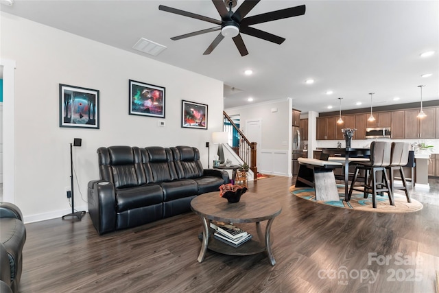 living area featuring recessed lighting, stairs, a ceiling fan, and dark wood-style flooring