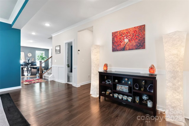 interior space featuring stairway, wood finished floors, baseboards, recessed lighting, and crown molding