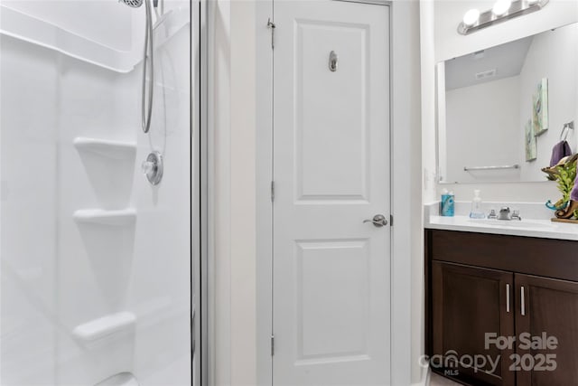 bathroom featuring a stall shower and vanity