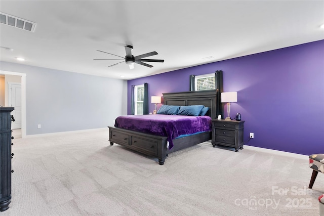 carpeted bedroom with a ceiling fan, baseboards, and visible vents