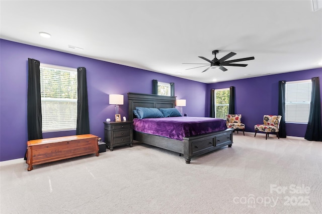 carpeted bedroom featuring baseboards and a ceiling fan