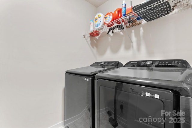 laundry room featuring washing machine and dryer and laundry area