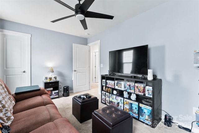 carpeted living area with a ceiling fan