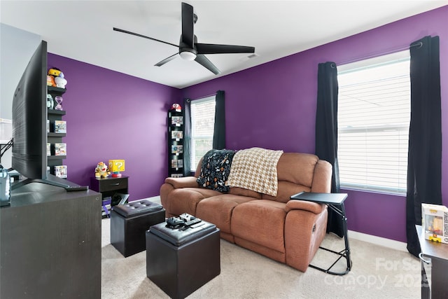 carpeted living room featuring visible vents, baseboards, and ceiling fan