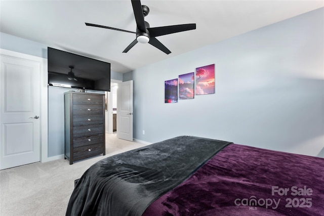 carpeted bedroom featuring a ceiling fan and baseboards