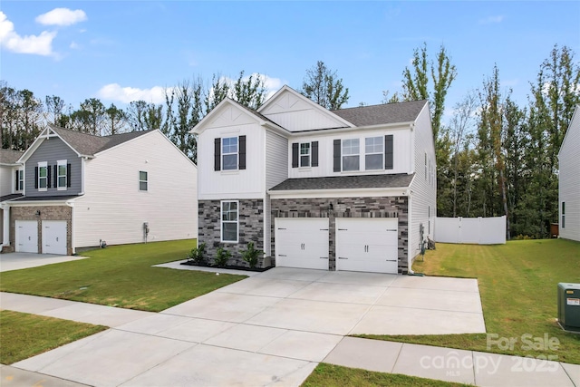 view of front of property featuring a garage, concrete driveway, a front lawn, and fence