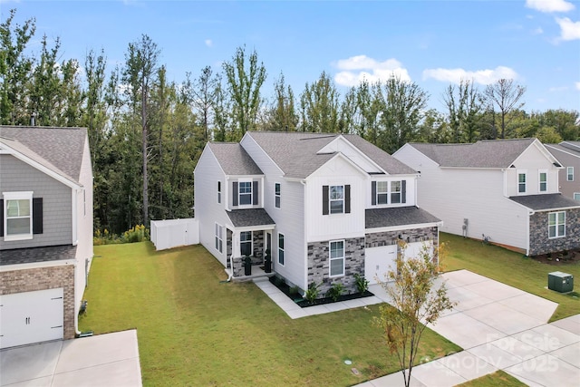 traditional home featuring board and batten siding, central air condition unit, concrete driveway, roof with shingles, and an attached garage