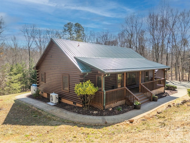 rear view of house with log exterior, a porch, crawl space, a standing seam roof, and metal roof