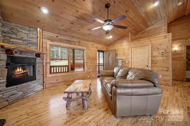 living area featuring wooden walls, ceiling fan, wood ceiling, and lofted ceiling