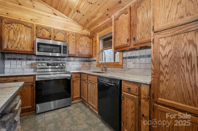 kitchen featuring appliances with stainless steel finishes, brown cabinetry, a sink, and lofted ceiling