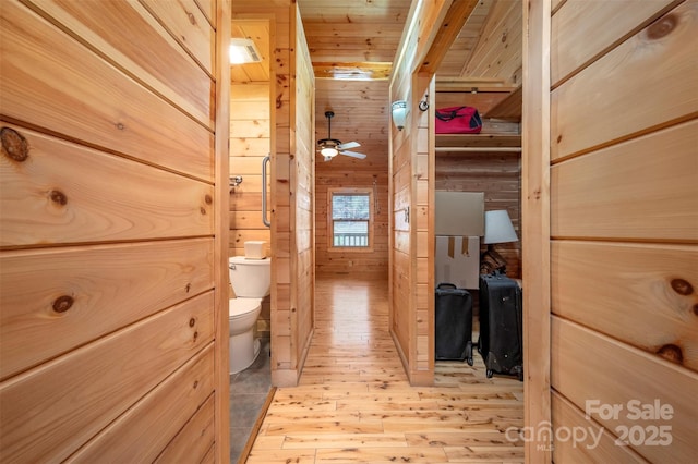 bathroom with toilet, wood walls, wood ceiling, and hardwood / wood-style flooring