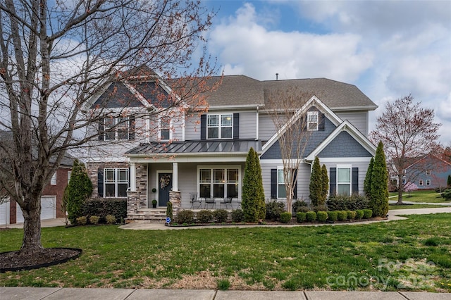 craftsman inspired home featuring a shingled roof, a front yard, covered porch, metal roof, and a standing seam roof