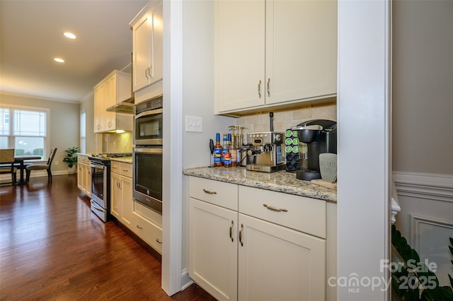 kitchen featuring white cabinetry, dark wood-style flooring, backsplash, and stainless steel appliances