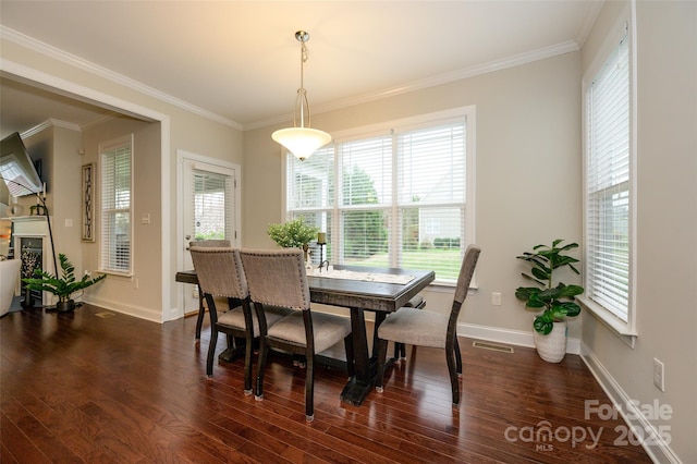 dining room with dark wood-style floors, visible vents, and ornamental molding