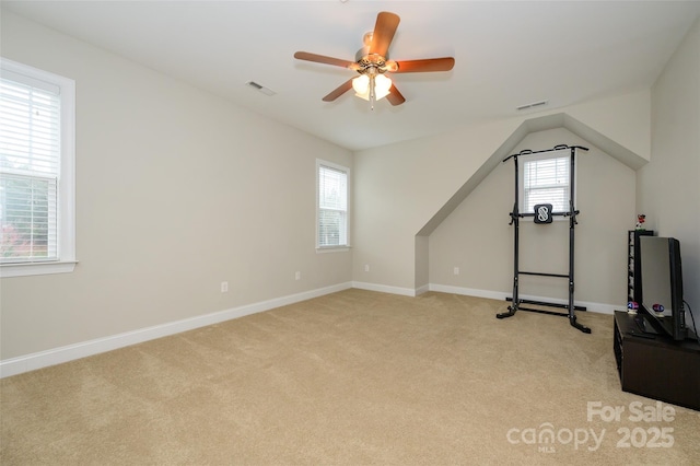 workout area with ceiling fan, baseboards, visible vents, and light carpet