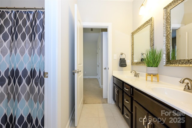 bathroom featuring a sink, a shower with curtain, double vanity, and tile patterned floors