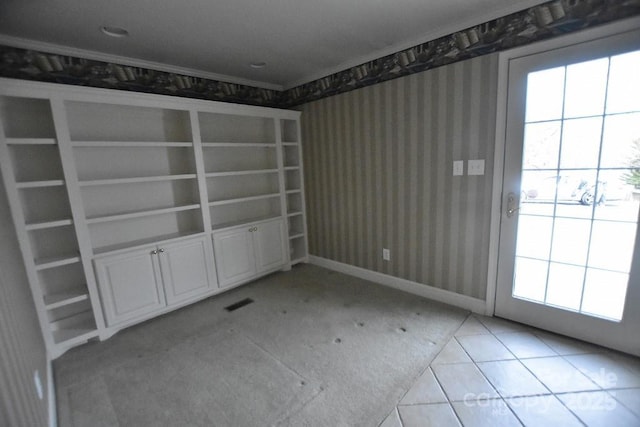 unfurnished room with wallpapered walls