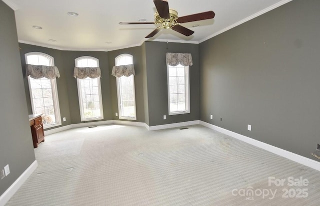 unfurnished room with light carpet, baseboards, and ornamental molding