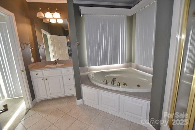 full bath with tile patterned floors, a garden tub, and vanity