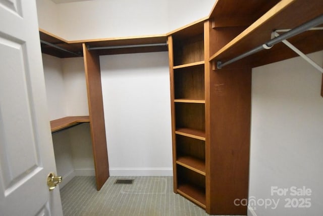 spacious closet featuring visible vents