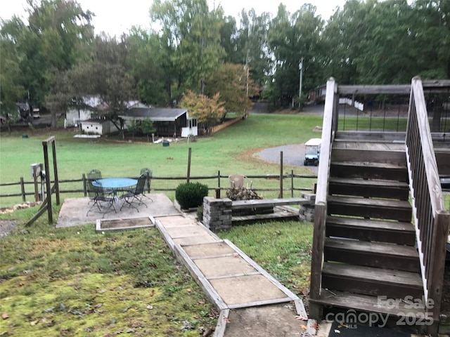 view of yard featuring stairway, a patio, and fence