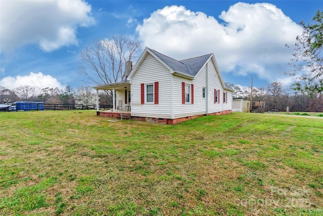 view of property exterior with crawl space, a lawn, a chimney, and fence