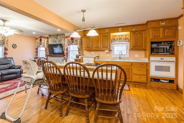 dining area featuring light wood-type flooring and a ceiling fan