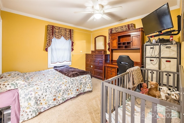 bedroom with ceiling fan, ornamental molding, and light carpet