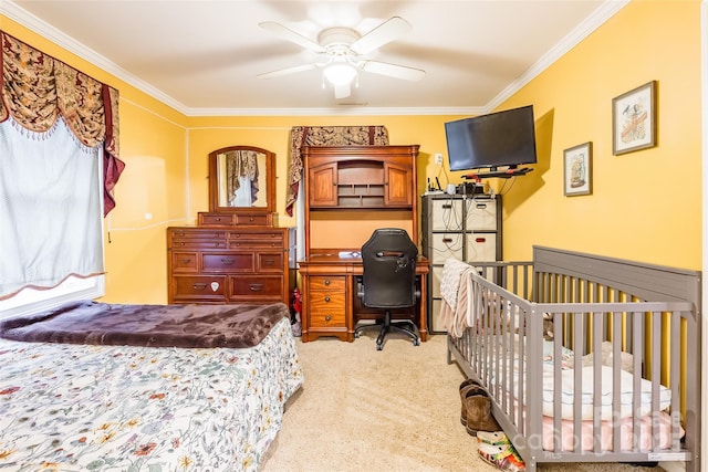 carpeted bedroom with ceiling fan and ornamental molding