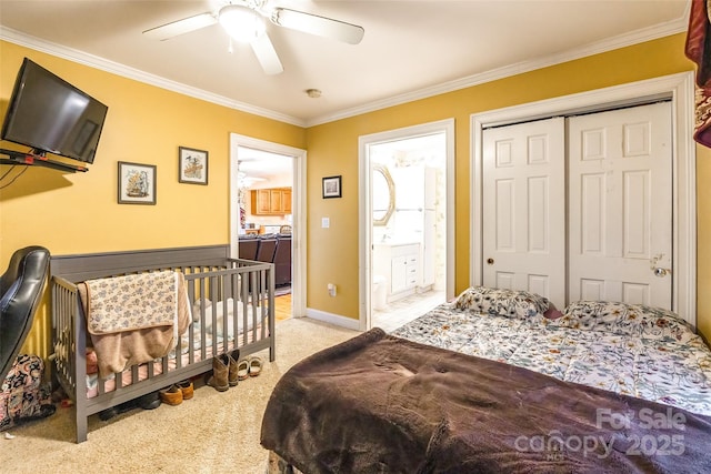 carpeted bedroom with a closet, crown molding, and ceiling fan