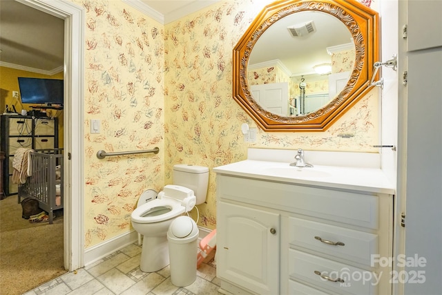 bathroom with wallpapered walls, crown molding, baseboards, toilet, and vanity