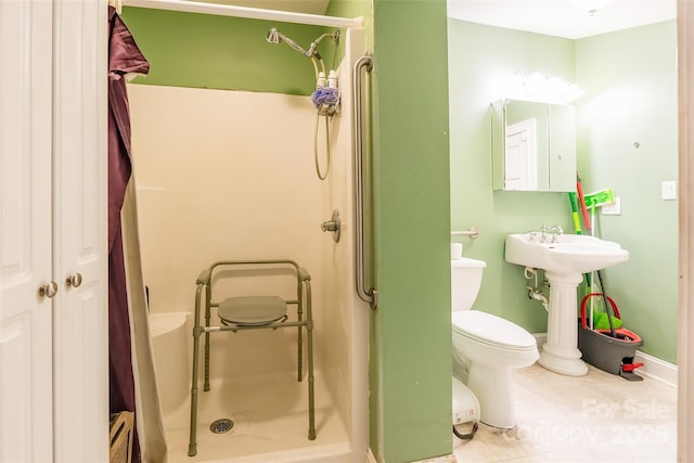 bathroom featuring tile patterned floors, toilet, a stall shower, a baseboard radiator, and baseboards