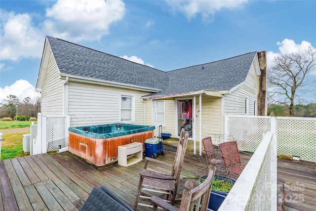 wooden deck featuring a hot tub