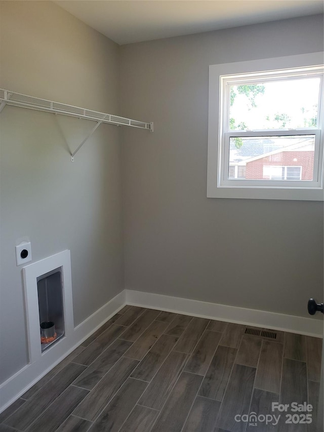 laundry room with wood finish floors, visible vents, hookup for an electric dryer, and laundry area