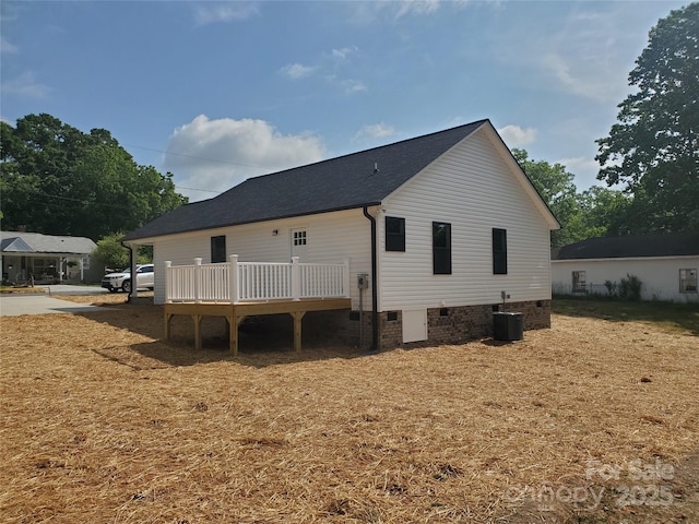 back of house with crawl space, cooling unit, and a deck