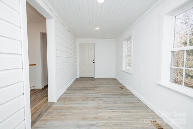 hallway featuring baseboards, recessed lighting, wood ceiling, and light wood-style floors