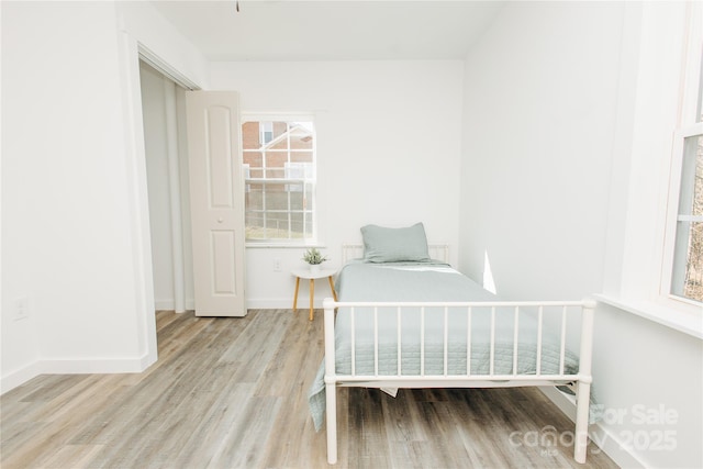 unfurnished bedroom featuring wood finished floors and baseboards