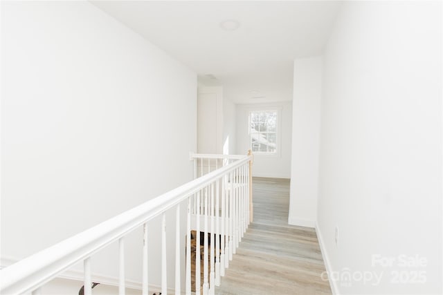 hall featuring wood finished floors and baseboards