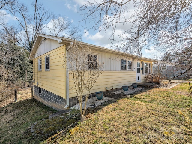 view of front of property with a front lawn, a gate, fence, and board and batten siding