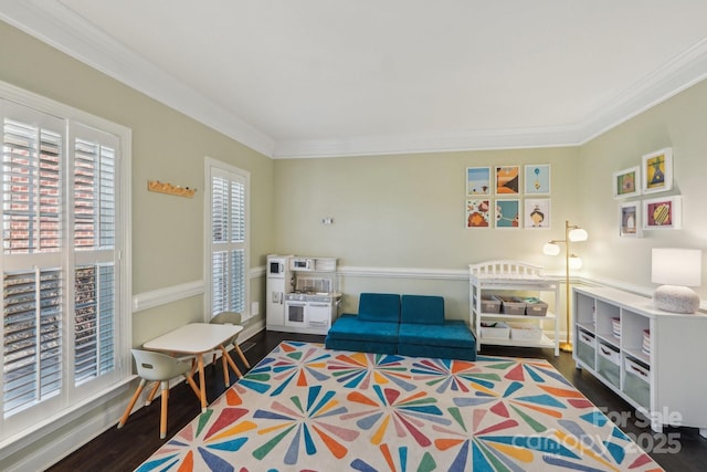 living area featuring wood finished floors and ornamental molding